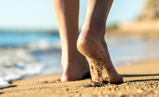 Bare feet walking along the shoreline
