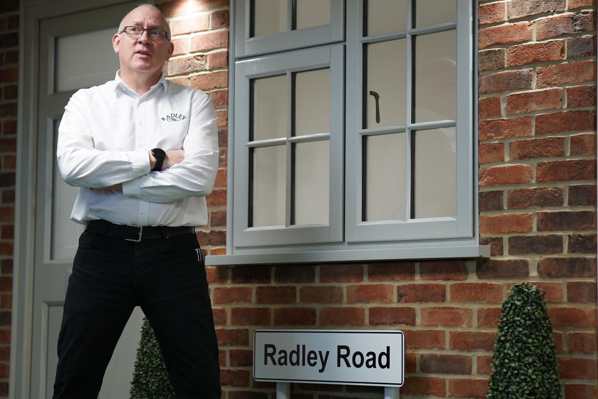 Radley team member beside a newly fitted cottage-style front door